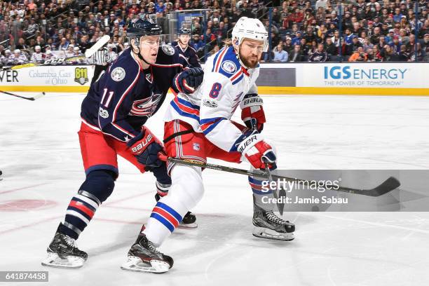 Matt Calvert of the Columbus Blue Jackets and Kevin Klein of the New York Rangers chase after a loose puck on February 13, 2017 at Nationwide Arena...