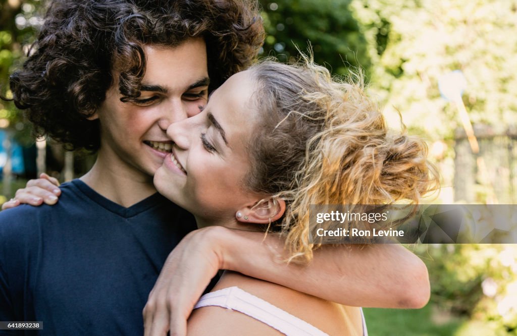 Hugging F Teen Couple In Park Hugging High-Res Stock Photo - Getty Images