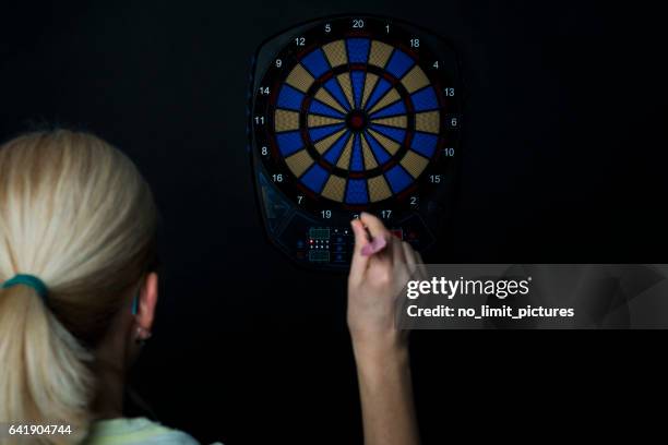 woman playing dart on electronic dartboard - throwing darts stock pictures, royalty-free photos & images
