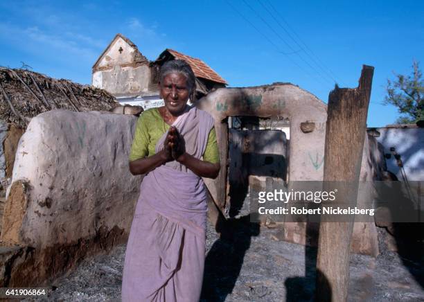 Woman from the Tevar caste whose house was burned makes a humble welcoming gesture to a visitor October 1, 1997 in Karaiyiruppu, India. Tevar caste...