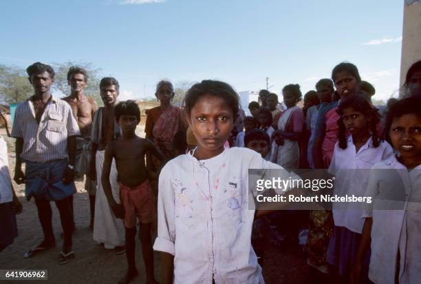 Young girl stands among members of the Tevar caste October 1, 1997 in Karaiyiruppu, India. Karaiyiruppu residents had witnessed a Dalit attack on...