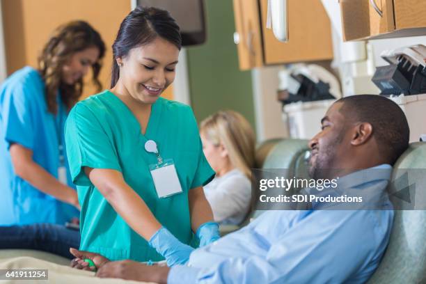 african american businessman donates blood during lunch break - give blood stock pictures, royalty-free photos & images