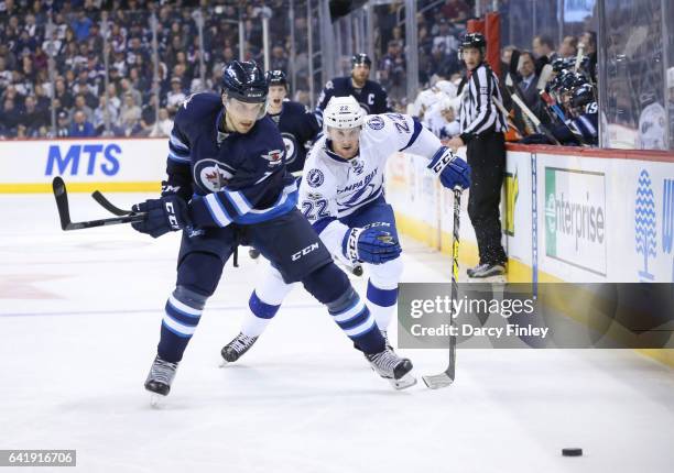 Ben Chiarot of the Winnipeg Jets and Erik Condra of the Tampa Bay Lightning chase the loose puck down the ice during third period action at the MTS...