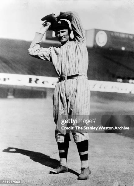 Walter Johnson, pitcher for the Washington Senators in a pitching stance, circa 1916.