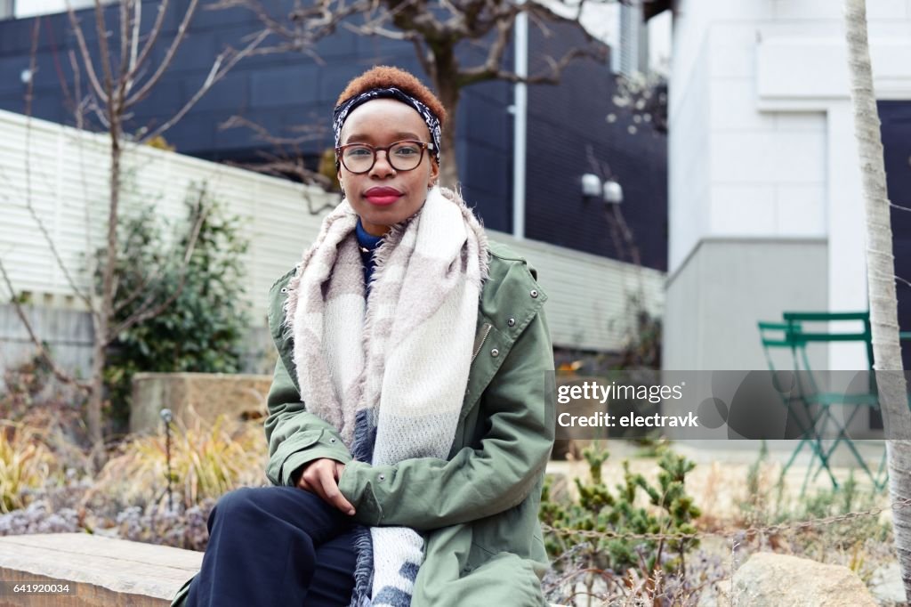 Young woman sitting outside