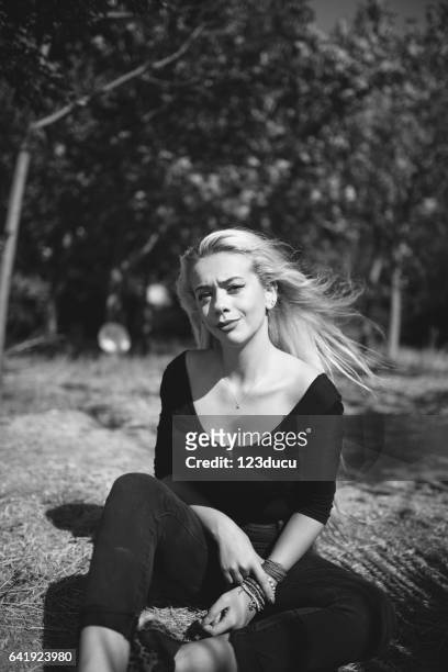 young blonde woman at forest - female looking away from camera serious thinking outside natural stock pictures, royalty-free photos & images
