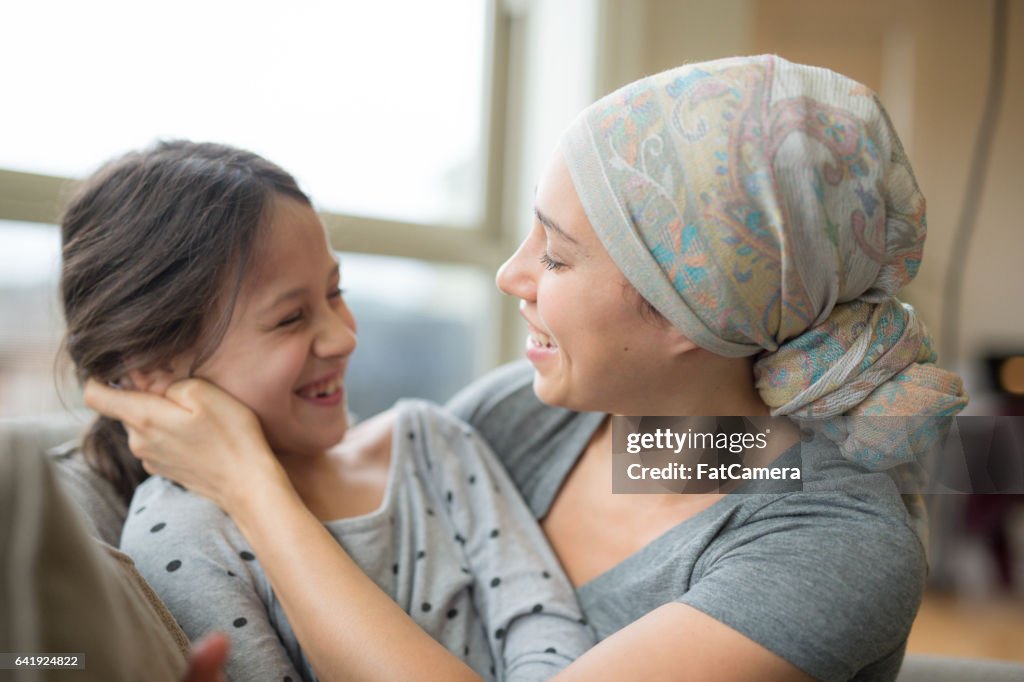 Mom with cancer holding daughter