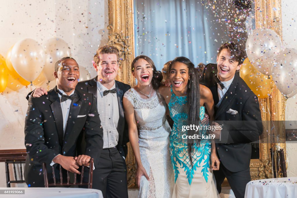 Teenagers and young adults in formalwear at party
