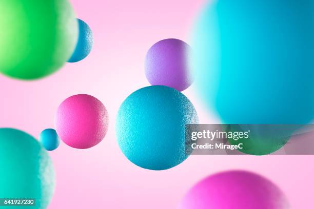 multi-colored balls in mid air - bouncing ball stockfoto's en -beelden