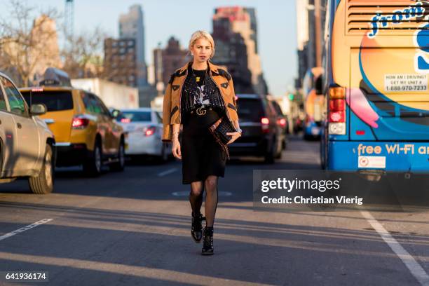 Caroline Daur wearing a brown jacket, black skirt outside Coach on February 14, 2017 in New York City.