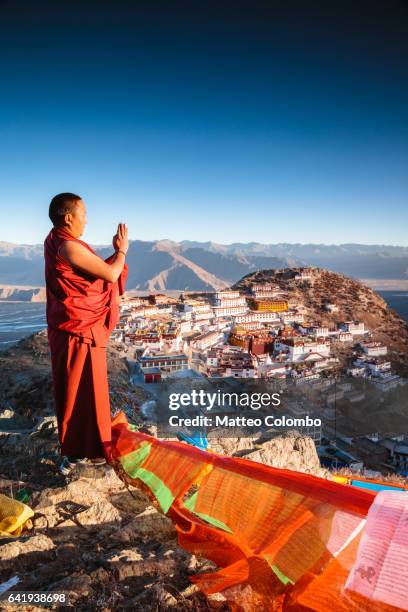 buddhist monk praying, ganden monastery, tibet - tibetan culture stock pictures, royalty-free photos & images