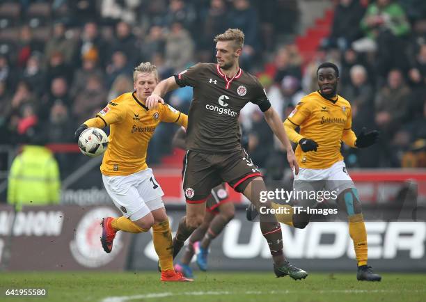 Marvin Stefaniak of Dynamo Dresden and Lasse Sobiech of St. Pauli , Erich Berko of Dynamo Dresden battle for the ball during the Second Bundesliga...