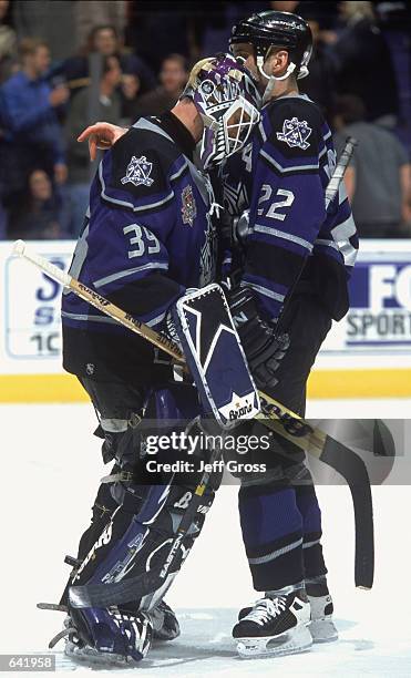 Goalkeeper Felix Potvin of the Los Angeles Kings hugging teammate Ian LaPerriere during the game against the St. Louis Blues at the Staples Center in...