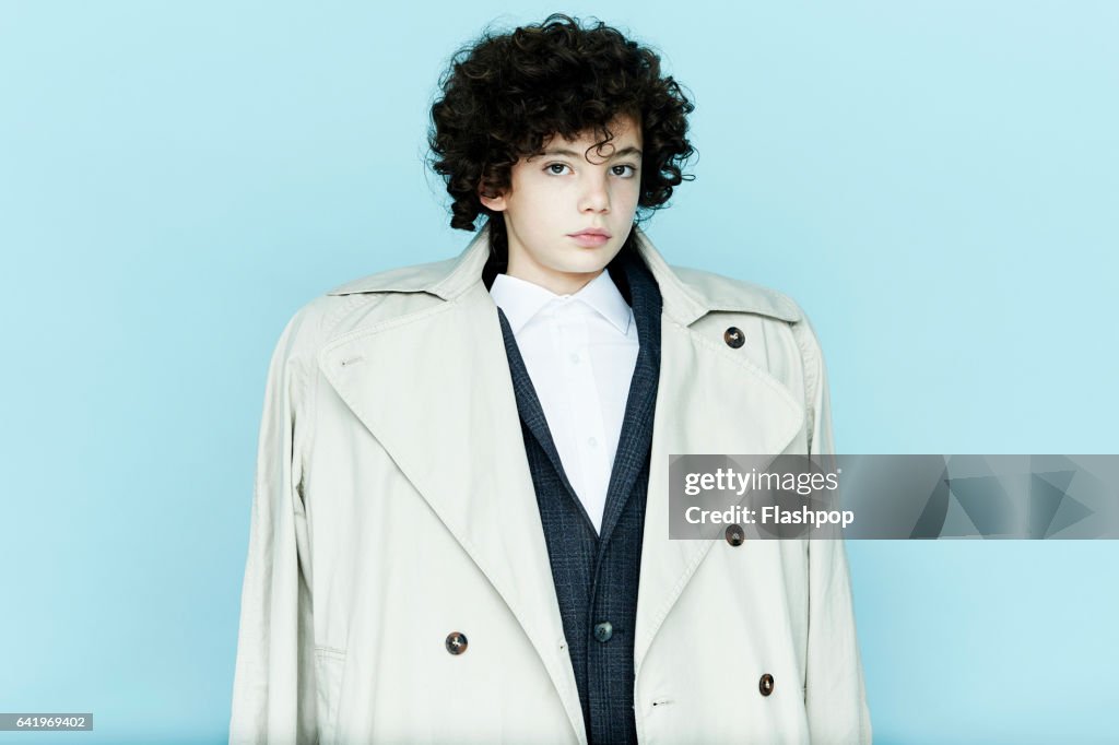 Portrait of boy wearing big coat