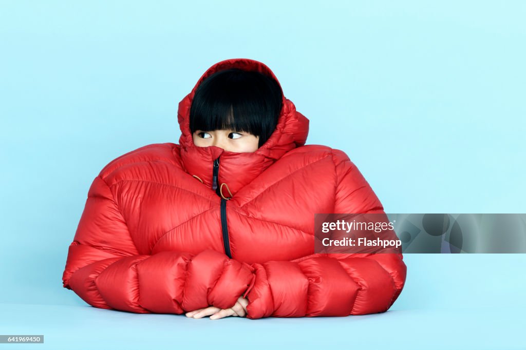 Portrait of girl wearing huge coat