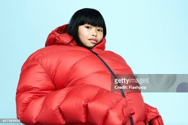 portrait of girl wearing huge coat - bizarre fashion photos et images de collection