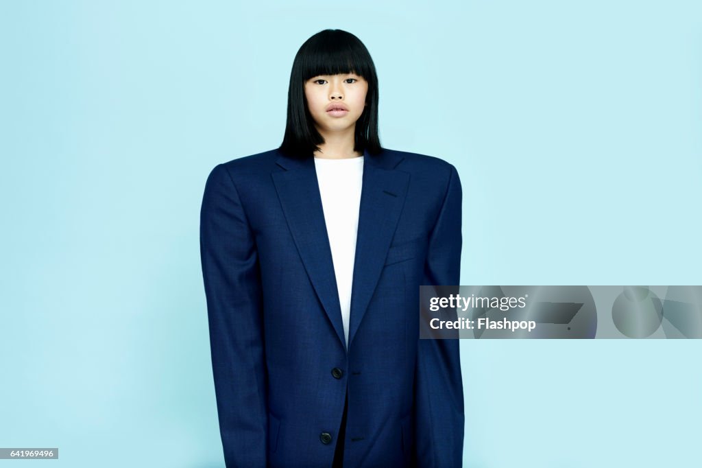 Portrait of girl wearing huge business suit