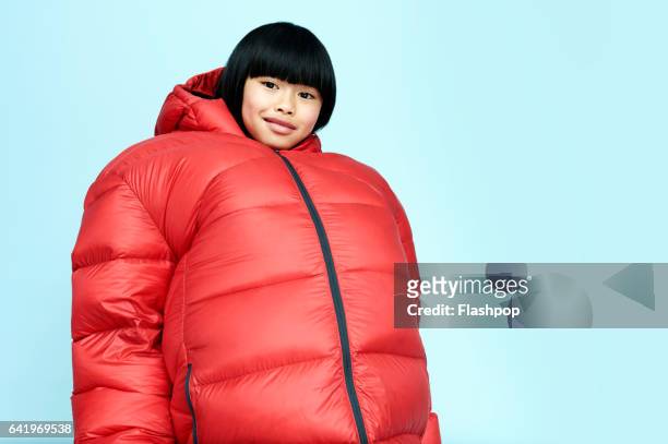 portrait of girl wearing huge coat - protective sportswear stock-fotos und bilder