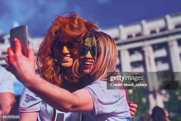 capture the happy moment - woman holi stock pictures, royalty-free photos & images