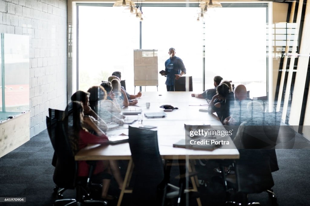 Businessman giving presentation in board room
