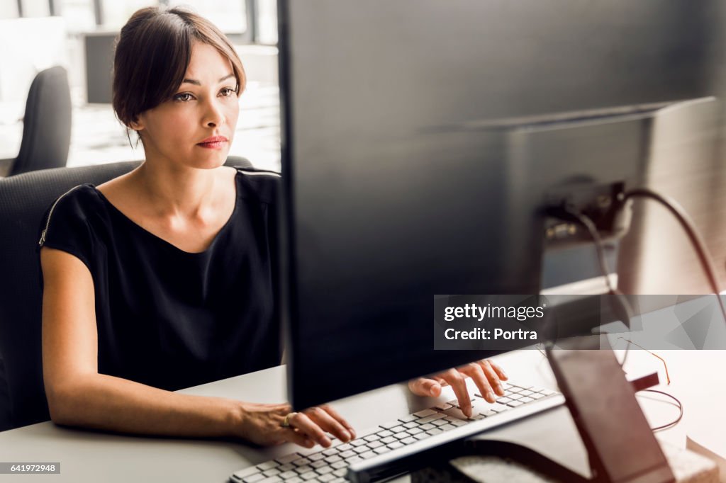 Woman Using Pc Businesswoman Using Desktop Pc At Office High-Res Stock Photo - Getty ...