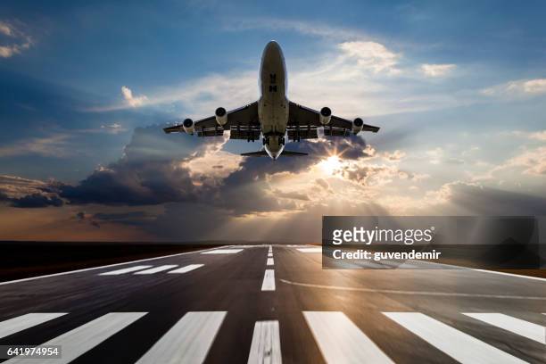 passenger airplane taking off at sunset - landing strip stock pictures, royalty-free photos & images