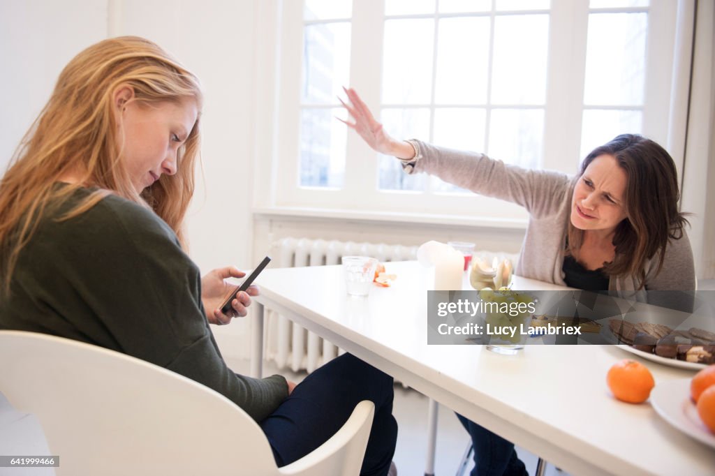 Young woman focussed on her smartphone
