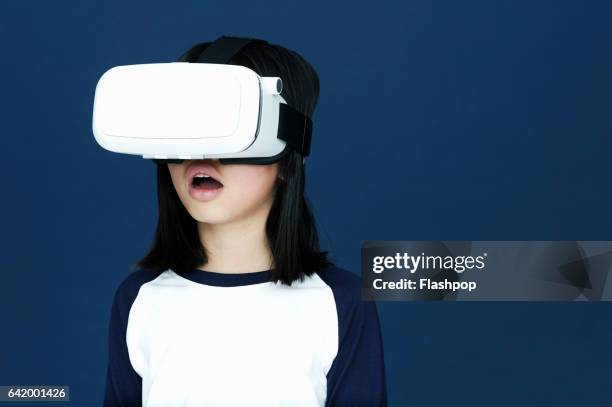 portrait of girl wearing virtual reality headset - virtualitytrend stock-fotos und bilder