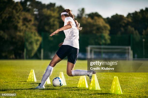 female soccer player - slalom drills training - soccer dribbling stock pictures, royalty-free photos & images