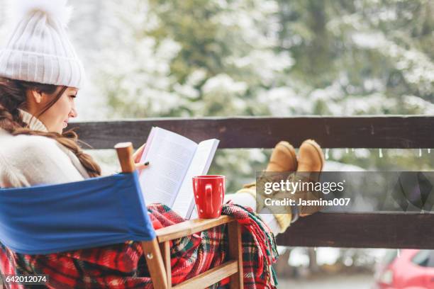 enjoying beautiful winter day - reading outside stock pictures, royalty-free photos & images