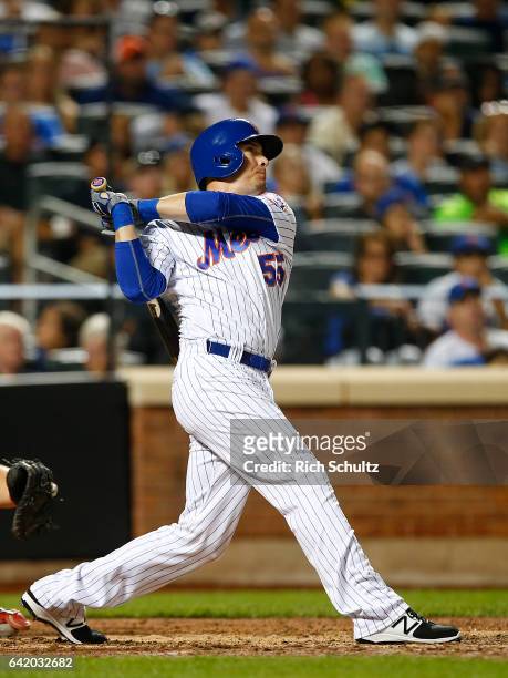 Kelly Johnson of the New York Mets hits a grand slam home run against the Philadelphia Phillies during the seventh inning of a game at Citi Field on...