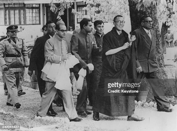 Tenzin Gyatso, the 14th Dalai Lama, arrives at Birla House in Mussoorie, India, after fleeing from Tibet, April 1959. Photo by Keystone/Hulton...