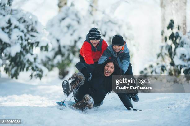 mom and sons playing in snow - december stock pictures, royalty-free photos & images