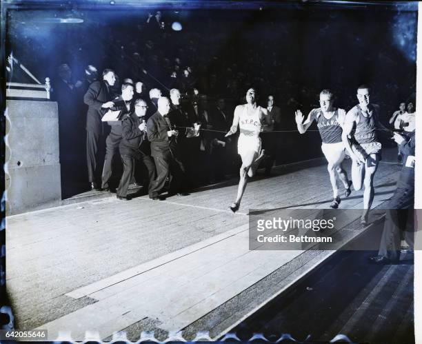 New York, NY: Roscoe Brown , of the NY Pioneer Club, is shown winning the 880-yard dash at the 45th annual Millrose Games at Madison Square Garden....