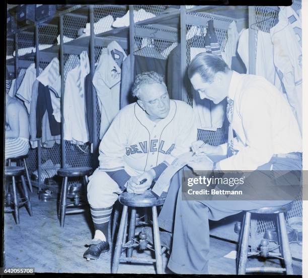 St. Louis, MO: Lou Boudreau , manager of the Cleveland Indians, and Steve O'Neill, coach, confer on the lineup before their season's opener with the...