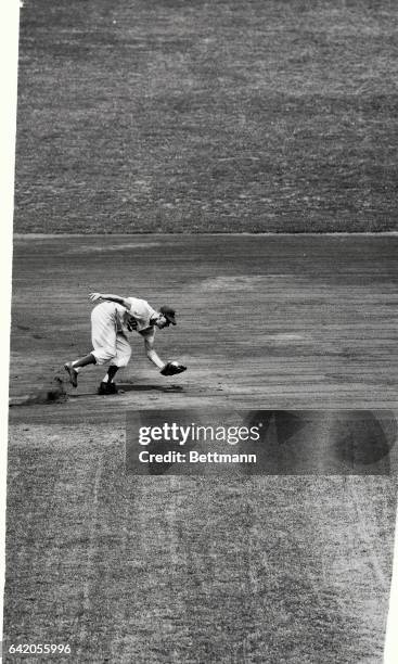 Don Hoak, Dodgers thirdbaseman, scoops up Gene Bakers grounder during the first inning of the Brooklyn-Chicago Cubs game at Ebbets field, July 29th....