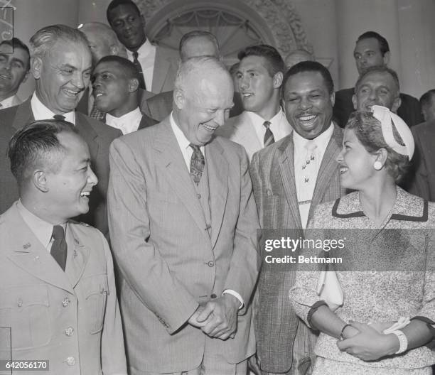 Washington, D. C.: Just For Laughs. President Eisenhower enjoys a chuckle with champion golfer Barbara Romack and ex champion Archie Moore. The Chief...