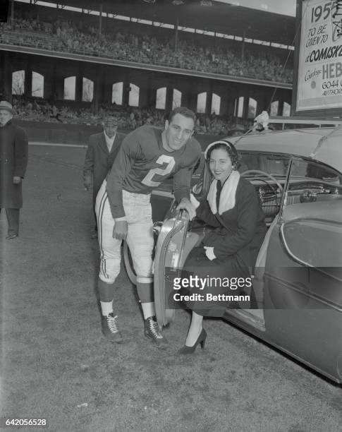 Charley Trippi, Chicago Cardinal backfield star, and his wife, stand by their new car which was given to Charley by the fans during a pre-game...
