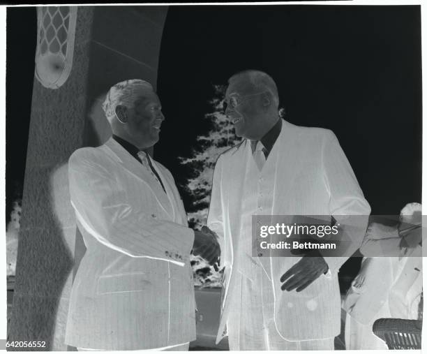 In Yugoslavia for the first time, United States Secretary of State John Foster Dulles, , is welcomed with a smile and a handshake by President Josip...