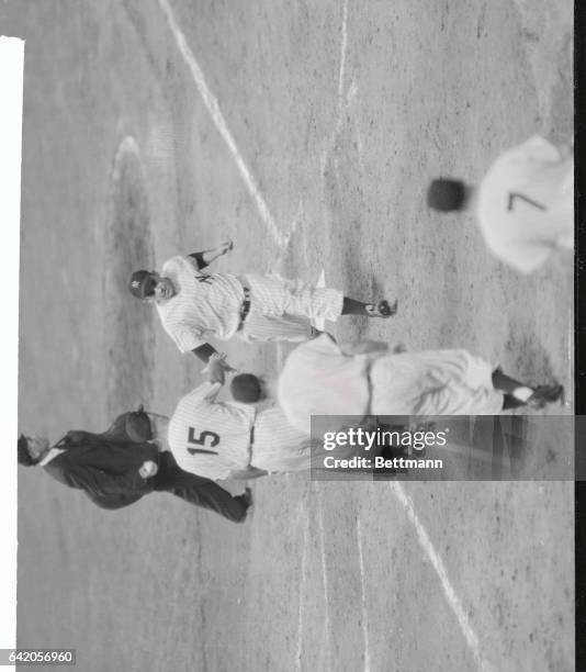 Yogi Berra of the Yanks gets the glad hand from Eddie Collins as he crosses the plate on his three-run homer in the fourth inning of tonight's clash...