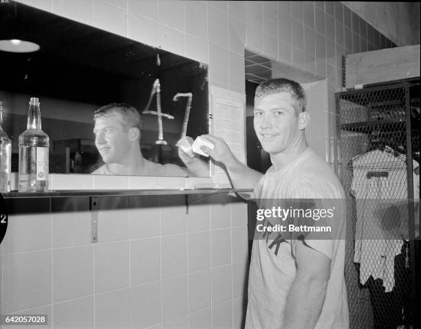 Yankee slugger Mickey Mantle soaps up a mirror in Griffith Stadium dressing room to record his 47th home run after blasting one over the right field...