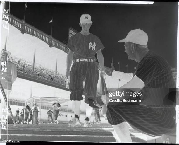 Billy Martin advances toward the dugout at Yankee Stadium today under the watchful eyes of Yankee pilot Casey Stengel, who announced his intention of...