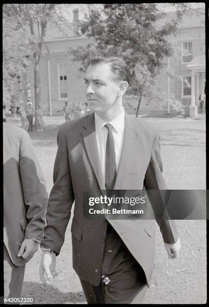 Melvin Davis Rees, dance band guitarist, handcuffed to a U.S. Marshall, arrives at courthouse where he is standing trial for the murder of Carroll...
