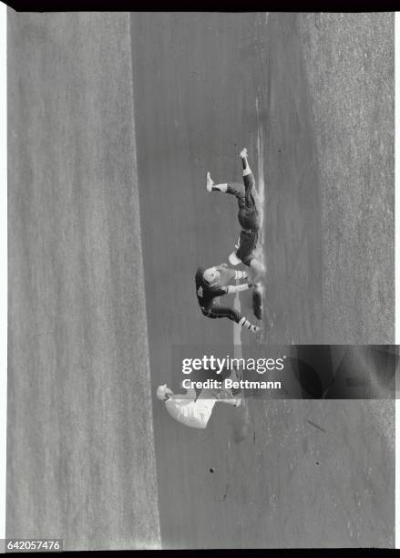 Mickey Mantle scrambles safely back to second after Braves pitcher Buhl tried to pick him off in the first inning of the third game of the World...