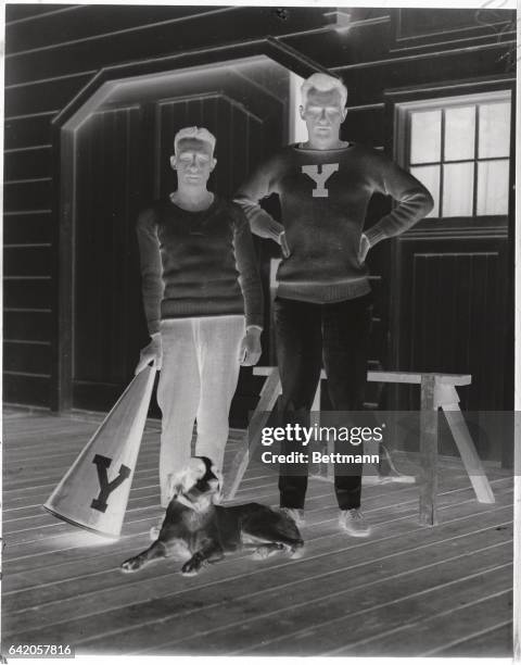Yale Varsity Crew Preparing for Crimson. Head coach George Corderry with Capt. Langhorne Gibson of the varsity crew, with their dog mascot.