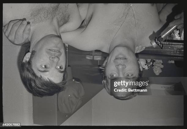 Cinncinati Red's Johnny Bench and Pete Rose in dressing room following first game of the Reds-Mets playoffs.