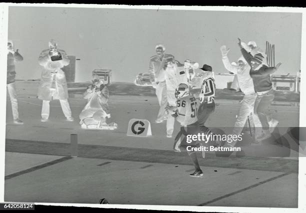 Defensive star of the Giants Lawrence Taylor is cheered as he runs back interception for a touchdown against the 49ers here. San Francisco...