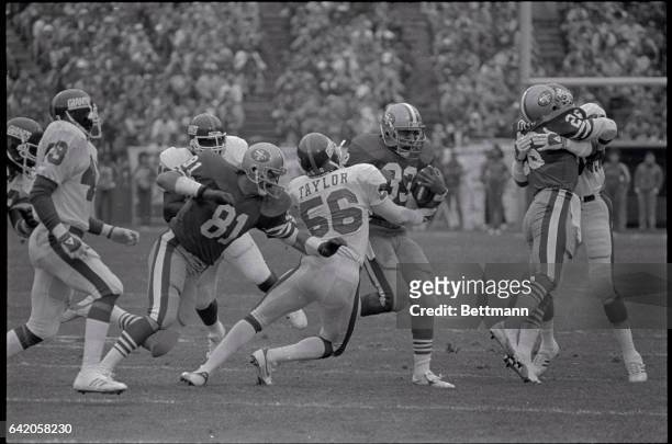 San Francisco 49er running back Roger Craig dodges around New York Giant defensive back Lawrence Taylor during the 2nd period action of their game at...