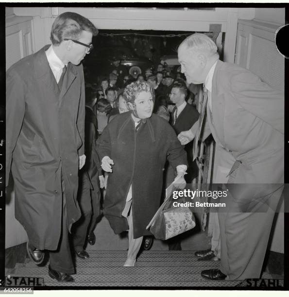 Judy Garland, is shown here with curlers in her hair, entering Carnegie Hall.