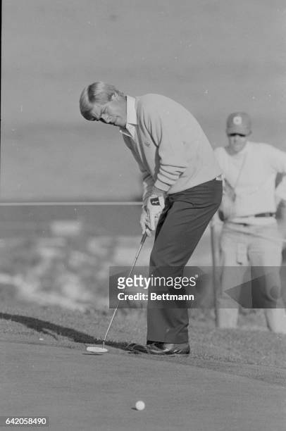 Pebble Beach, Calif.: Hal Sutton puts a little body english on his ball after firing a 35-foot putt on the 2nd green at the Spyglass Hill course,...